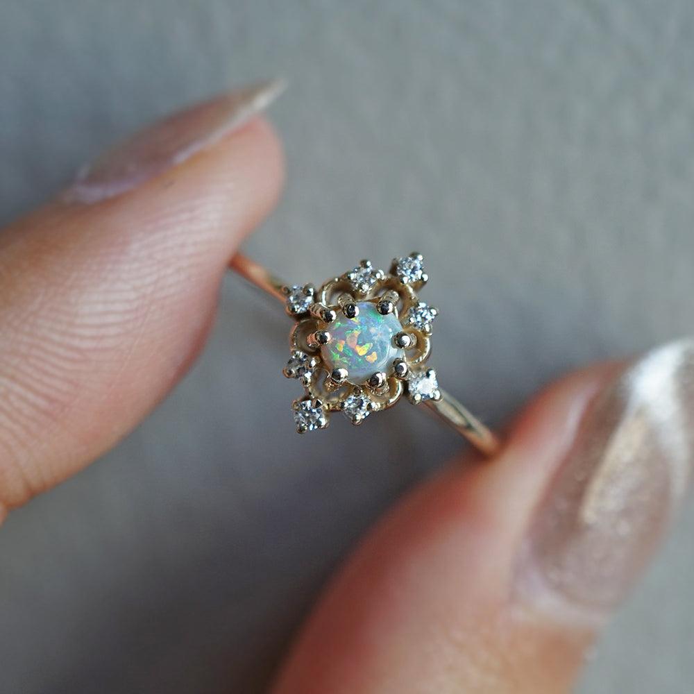 Opulent Opal Venetian Ring featuring a natural Australian opal center stone, set in a 14K gold band with intricate Venetian design. The mesmerizing play of colors within the opal captures nature's beauty and adds a touch of elegance to your style.