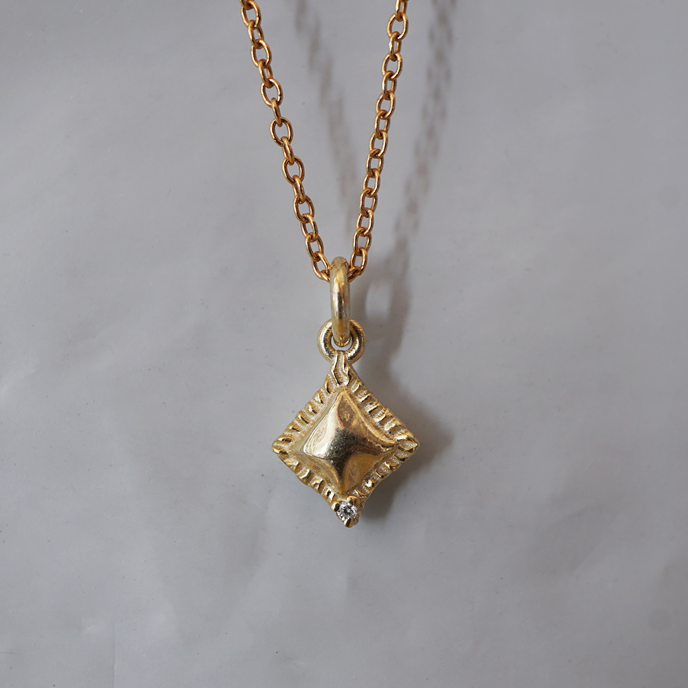 Al Dente solid gold ravioli charm with crimped edge and a natural diamond